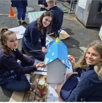 Students painting a street library