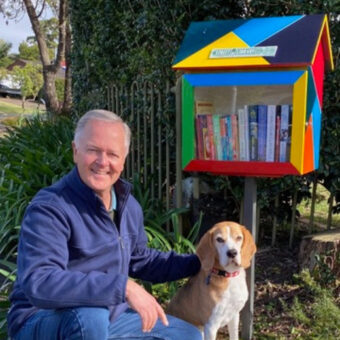 A man and his dog with their Street Library