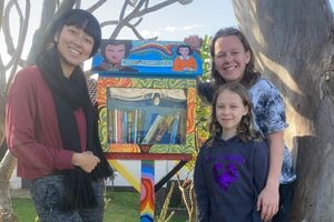 Two women and their daughter posing with their Street Library