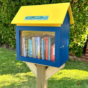A blue and yellow version of Street Library Australia's 'The Shed'.