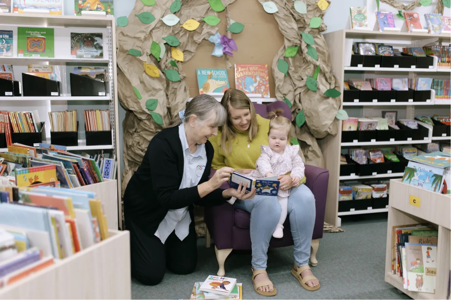 A mother, child and a librarian reading in Gilgandra Library, NSW