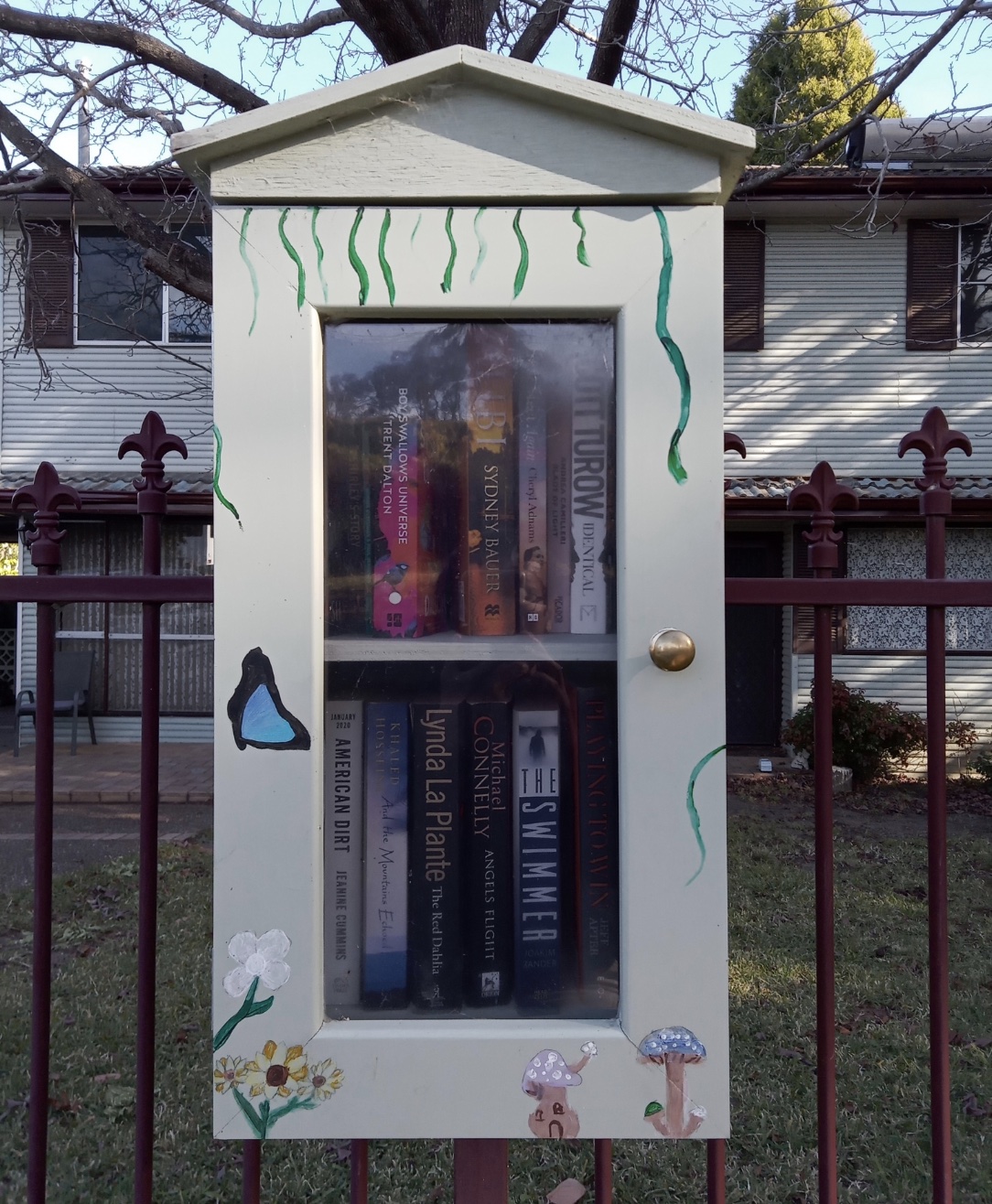 A bespoke Street Library decorated with mushrooms and butterflies.