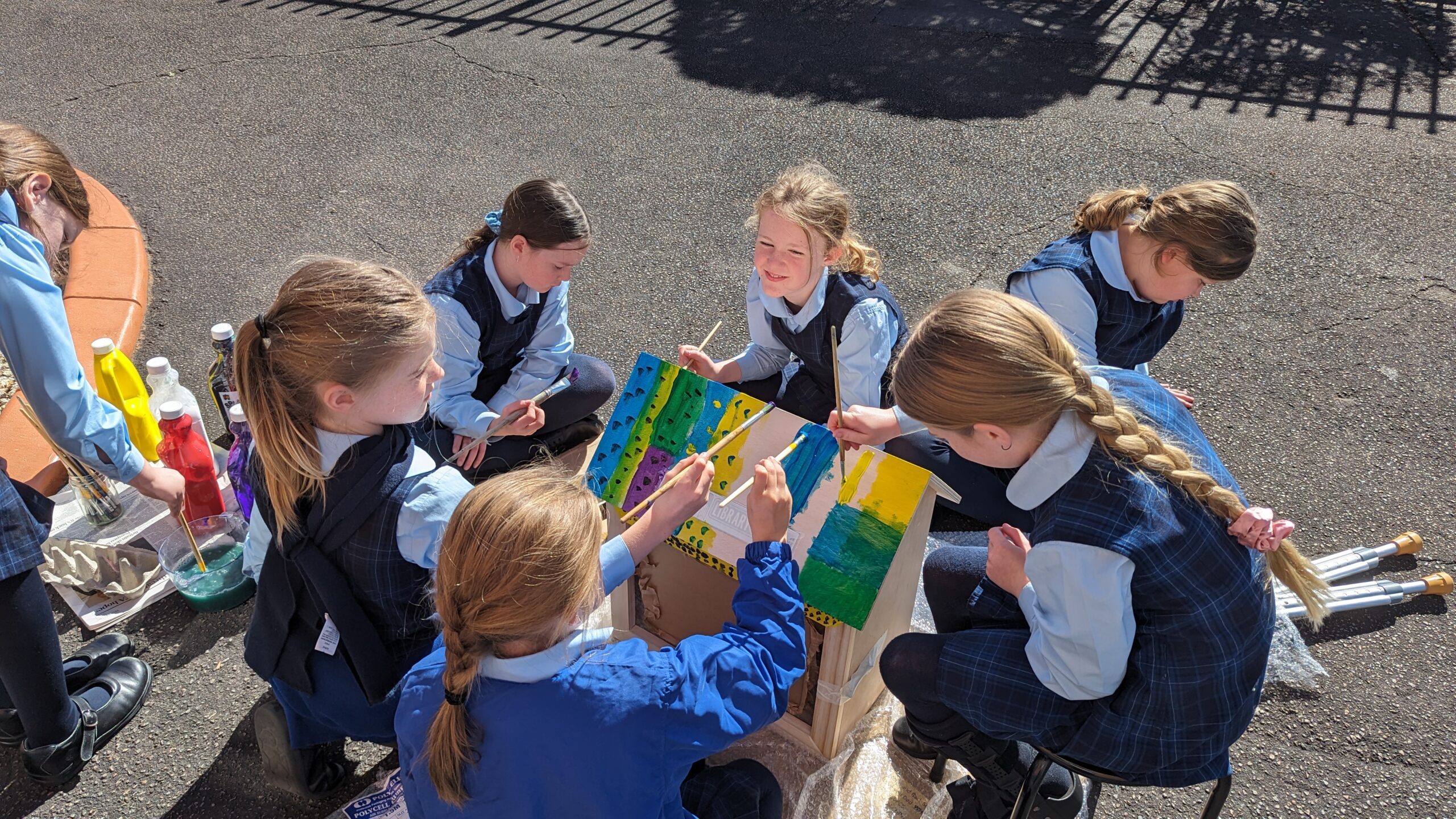 Children from Holy Spirit Primary School decorate their Street Library.